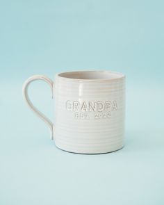 a white ceramic mug with the name grandpa on it