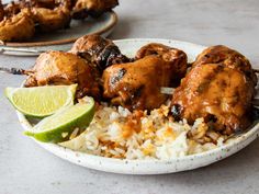 chicken and rice on a plate with lime wedges next to the plate in which it is cooked