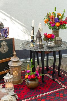 a table with flowers and candles on it