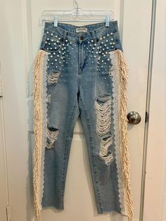 Size:  5 Waist:  28" Hips:  40" (measured 10" down from waist).  In seams:  27 1/2" This is a very beautiful jeans for very special occasions.  Wear it to your bachelorette parties, country wedding, concerts/festivals.  It's embellished with pearls, lace and cream fringes that adds a lot of drama ina subtle way.  It's  romantic, classy and vintage fashion style.  It's truly a wearable art/statement piece. Bohemian Summer Jeans With Frayed Hem, Fitted Fringe Jeans For Spring, Embellished Fitted Jeans For Summer, Embellished Fitted Bohemian Bottoms, Bohemian Embellished Bottoms For Festival, Bohemian Fitted Embellished Bottoms, Bling Fringe Jeans, Bohemian Embellished Fitted Bottoms, Party Jeans With Rhinestone Fringe