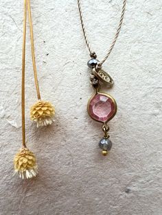 Unique a full of intrigue. Features a vintage lucite pink crystal charm, a labradorite gemstone, glass crystal bead, filigree brass charm, nylon cord. Select length on the menu. The necklace will be gift boxed. Delicate Adjustable Faceted Necklace, Pink Vintage Charm Pendant Jewelry, Dainty Flower Pendant Necklace With Vintage Charm, Handmade Adjustable Vintage Crystal Necklaces, Vintage Handmade Adjustable Crystal Necklaces, Adjustable Round Pendant Necklace With Vintage Charm, Adjustable Vintage Charm Round Pendant Necklace, Pink Dainty Pendant Crystal Necklace, Pink Vintage Charm Dangle Jewelry