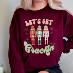 Description: Lets get crackin' ! One of my most beloved movies around Christmas time was, The Nut Cracker, so I absolutely adore this beautiful holiday design. This sweatshirt would make an amazing retro style gift for your person. It has that cute faded vintage look with a comical twist. Would be the perfect Christmas Eve or Secret Santa gift.  Details: This sweatshirt is a crewneck Gildan 18000 and is unisex sizing. This garment runs true to size and is cotton. Novelty Christmas Crew Neck Top, Christmas Novelty Crew Neck Tops, Novelty Crew Neck Tops For Christmas, Retro Christmas Shirt, Beloved Movie, Nut Cracker, Sweater Christmas, Sweatshirt Christmas, Secret Santa Gifts