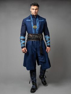 a man dressed in blue and black is posing for the camera with his hands on his hips