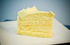 a piece of cake sitting on top of a white plate with frosted icing