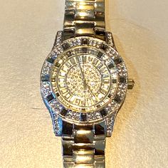 Brand New, Exquisite! Beautiful Simulated Baguettes And Round Diamonds And Blue Sapphires Inside Face And Outside, For The Person That Likes To Look Like A Million Dollars. Stainless Steel Back With Quartz Movements. Great Condition Except Needs New Battery. Fits Wrist Size Medium To Large Measures Approximately 8 Inch’s , Can Have Link’s Removed If Too Large. Code# B9825 Designer Silver Diamond Watch With Diamond Accents, Formal White Gold Watches With Rhinestones, Silver Diamond Watch For Evening With Round Dial, Luxury Silver Jewelry And Watches With Bling, Luxury Silver Bling Jewelry And Watches, Luxury Formal Watches With Rhinestones, Silver Bling Jewelry And Watches As Gift, Formal Watches With Rhinestones, Elegant Silver Diamond Watch For Party