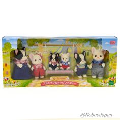 three small toy mice are sitting on a bench in front of a box with japanese characters