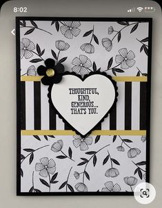 a handmade card with a heart on the front and black and white flowers on the back