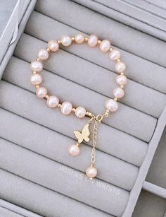 "Real Pearl Bracelet, Pink Peach Freshwater Pearl Bracelet with 14K Gold-Plated Butterfly Charm Bracelet, Bridesmaids Bracelet, Wedding Gifts This bracelet is simple and elegant. It's perfect for daily wear adding a unique sense to any outfit. It is also a wonderful gift for your family or friends. Material: - Pink freshwater pearl round 7-8 inches - 14k gold plated butterfly charm - 14k gold plated chain, spring ring, spacers Your bracelet will arrive in a jewelry box ❖ The pearls are natural, each bead is unique and beautiful so please expect slight variations in color, texture, and size. The bracelet is made to order, as the bracelet length must be based on your wrist size. The one in the picture is approximately 6.5 inches long and 1.5 inches extending chain. ❖ BRACELET SIZE We make al Simple Charm Bracelet, Pink And Gold Bracelet, Cute Pink Pearl Bracelet For Gift, Rose Gold Bracelet With Pearl Charm For Gift, Elegant Pink Pearl Bracelet For Gifts, Rose Gold Bracelet With Pearl Charm, Elegant Rose Gold Bracelet With Pearl Charm, Real Pearl Bracelet, Hand Jewelry Rings