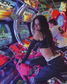 a woman sitting on top of a pink motorcycle in front of a slot machine at a casino