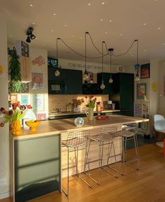 a kitchen with wooden floors and lots of counter space next to a dining room table