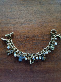 Here is the ultimate girly girl charm bracelet from yesteryear. Each charm showcases some fashion must-haves from the 1950's: cool outfits, high-heel shoes, purses, and sunglasses. Enhanced with faux pearls and faceted yellow beads, this great piece of costume jewelry from DONA checks all the boxes for a fun vintage charm bracelet. According to my research, the mark S.F. on DONA jewelry signifies gold finish over silver.  The bracelet is in great condition and waiting for someone who appreciates this type of vintage fashion jewelry. Briarcliff Manor, Vintage Charm Bracelet, Waiting For Someone, Heel Shoes, Girly Girl, Vintage Charms, Vintage Gold, Gold Finish, High Heel Shoes