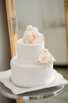 a white wedding cake sitting on top of a table