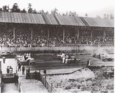 an old black and white photo of a race track