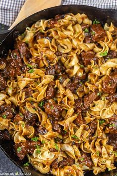 a skillet filled with beef and noodles