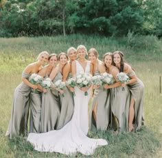 a group of women standing next to each other in a field