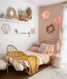 a bed room with a neatly made bed and some decorations on the wall above it