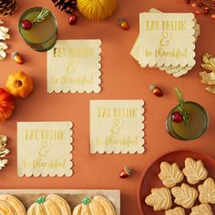 the table is covered with cookies and place cards