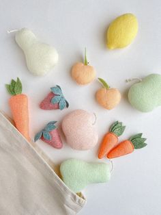 small felt fruits and vegetables on a white surface