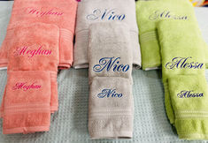 towels with names on them are lined up in a row and placed next to each other