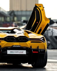 a yellow sports car with its door open