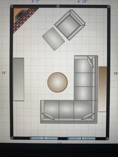 an overhead view of a living room with furniture and floor plans on the computer screen