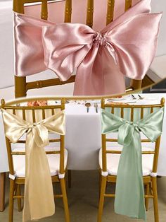 two chairs with pink and green bows tied to the back of them, sitting next to each other