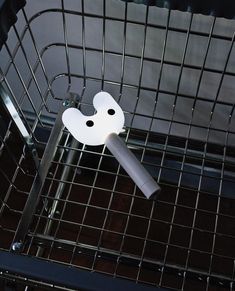 a white object in a metal cage on the floor