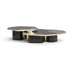 two tables with black marble and gold accents on each table, one is shaped like an oval