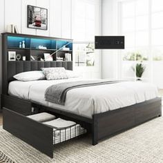 a bed with drawers underneath it in a white and black bedroom setting on carpeted flooring