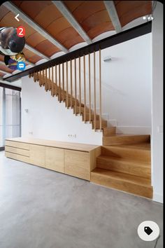 an empty room with some stairs and wooden railings on the wall next to it