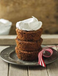 three cookies stacked on top of each other with whipped cream in the middle and candy cane