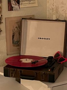 a record player sitting on top of a suitcase