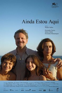 a man and two women standing next to each other in front of the ocean with their arms around them