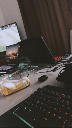 a desk with two monitors and keyboard on it