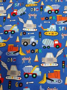 a blue fabric with construction vehicles on it