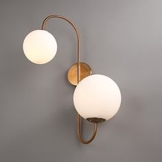 Add a soft and soothing glow to your living room, bedroom, and bathroom with this modern chic indoor wall lamp. Full of sculpturally minimalist and regal symmetry, this warmly elegant wall sconce is sure to add chic styling to your home decor. Manufactured from a sturdy metal construction and coated in an aged brass finish, it helps to provide you with reliable and durable service. Double white glass globes cap top and bottom, creating a lovely balance to the frame. Chic and effortless, this charming light fixture gives your contemporary or transitional decorating style a classy finishing touch. Corrigan Studio® | Corrigan Studio® Holten 2 - Light Modern Wall Sconce White Globe Glass Shade Wall Lamp in Aged Brass 22.4 H x 11.8 W x 7.9 D | 23.6" H X 16.1" W X 11.8" D | Wayfair Transitional Style Decor, Shade Wall, Glass Globes, Decorating Style, Modern Wall Sconces, Transitional Decor, Modern Chic, Aged Brass, Glass Globe