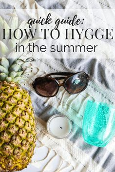 a pineapple and sunglasses on a towel with text overlay that reads quick guide how to hygge in the summer