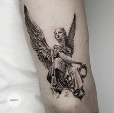 an angel tattoo on the arm of a man