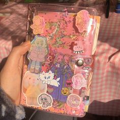 a person holding up a case with stickers on it