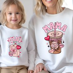 "Valentines Mama Mini Matching Sweatshirts, Mommy And Me Sweatshirts, Kids Toddler Christmas Sweatshirt, Christmas Sweatshirt, Gift For Mama If you are looking for soft, comfortable, premium sweatshirts and hoodies you are in the right place! A B O U T   O U R   P R O D U C T S *Hoodie -Adult unisex sizing,  -Tear away label,  -Ribbed collar,  -Cuffs and waistband with spandex,  -Pouch pocket, double-blend hoodie with matching drawstring  -Mid-weight 8.0 oz. -50% cotton, 50% polyester -Heather sport colors are 60%  polyester, 40% cotton *Sweatshirt -Adult unisex sizing,  -8 oz.(US) 13.3 oz.(CA), 50/50 preshrunk cotton/polyester - Air jet yarn = softer feel and reduced pilling - Double needle stitching at shoulder, armhole, neck,waistband and cuffs  -1 x 1 rib with spandex -Quarter-turned t White Long Sleeve Matching T-shirt, Family Matching Long Sleeve Tops With Cartoon Print, Family Matching Long Sleeve Tops With Custom Print, Cute Graphic Print Sweatshirt For Gift, Winter Birthday Tops With Graphic Print, Winter Birthday Top With Graphic Print, Cute Long Sleeve T-shirt As Gift, White Tops With Cartoon Print Matching Style, Long Sleeve Sweatshirt For Mother's Day Gift