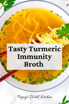 a bowl of tasty tumericic community broth with noodles and parsley