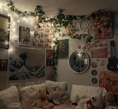 a living room filled with lots of stuffed animals and pictures on the wall above it