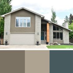 the exterior of a house with gray paint and brown trim on the front, green trees in the background