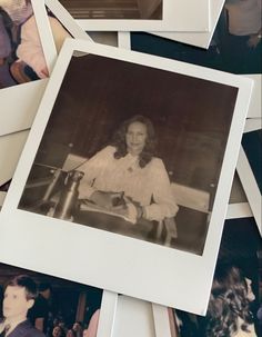 an old photo of a woman sitting at a table