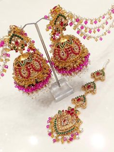 This beautiful piece of jewellery, the Laraib Jhumka Teeka with 3 Layers Sahare, is perfect for any special occasion. With its unique design featuring multicoloured natural stone beads, this Indian/Pakistani bridalwear partywear accessory is sure to catch everyone's eye. Crafted in India with excellent cut grade and multiple gemstones, this piece showcases the stunning beauty and intricate craftsmanship of Pakistani jewellery. It is an ideal gift for someone special on occasions like Engagement, Festival Wedding Sets With Latkans, Wedding Sets With Latkans For Festivals, Wedding And Festival Sets With Latkans, Traditional Sets With Latkans For Eid, Multicolor Wedding Choli With Latkans, Wedding Multicolor Choli With Latkans, Traditional Wedding Sets With Latkans, Heavy Bollywood Dupatta For Diwali, Bollywood-style Heavy Lehenga For Festivals