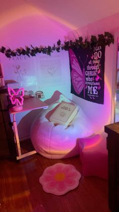 a room with pink lighting and decorations on the walls, including a bean bag chair