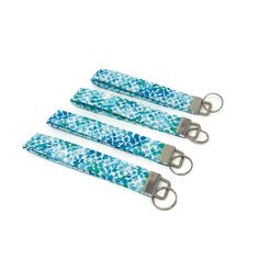 three blue and white keychains with metal handles on each side, one has an animal print design