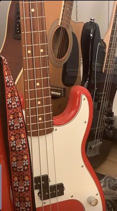 three guitars are lined up next to each other