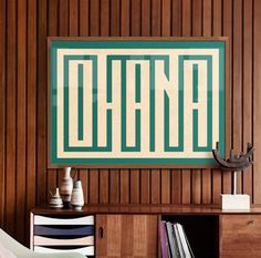 a room with wood paneling and a painting on the wall that says ohana