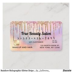 a beauty salon gift card with pink and gold drips on the front, white marble background